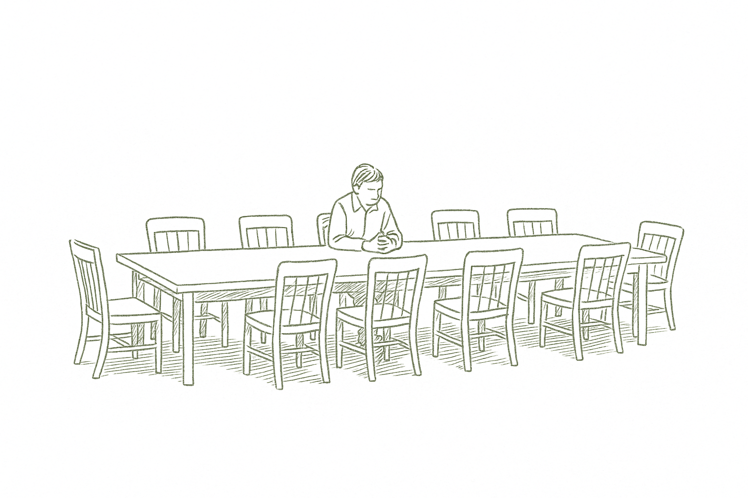 A founder sitting alone at a boardroom table